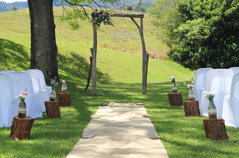Wedding aisle and timber arch on the lawn