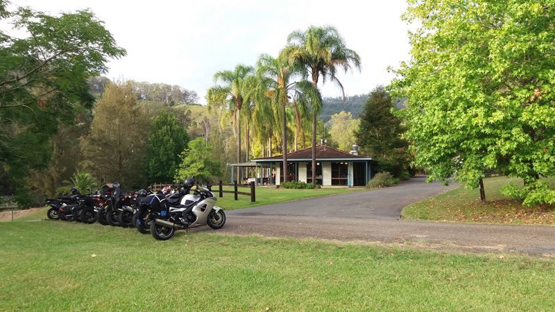 Motorcycles lined up on the lawn in front of the resort