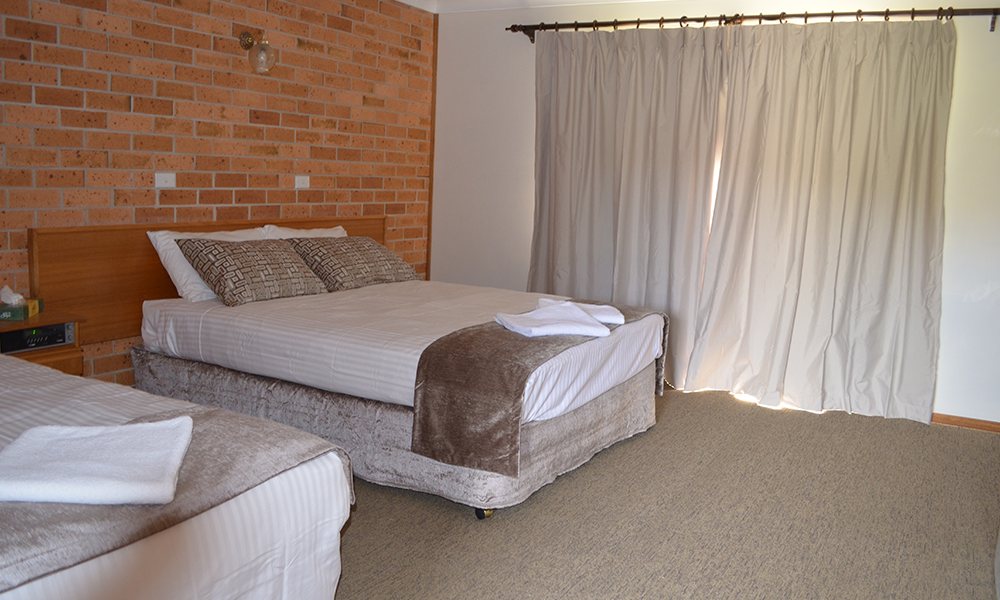 Valley View room with queen bed and exposed brick